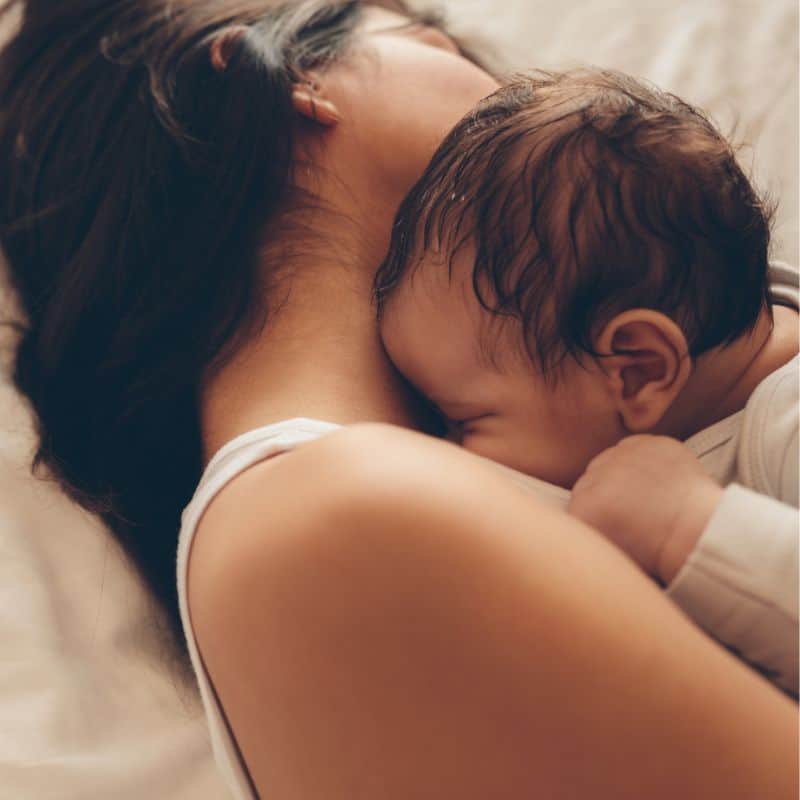 Sleeping mother and baby benefitting from toronto doula services