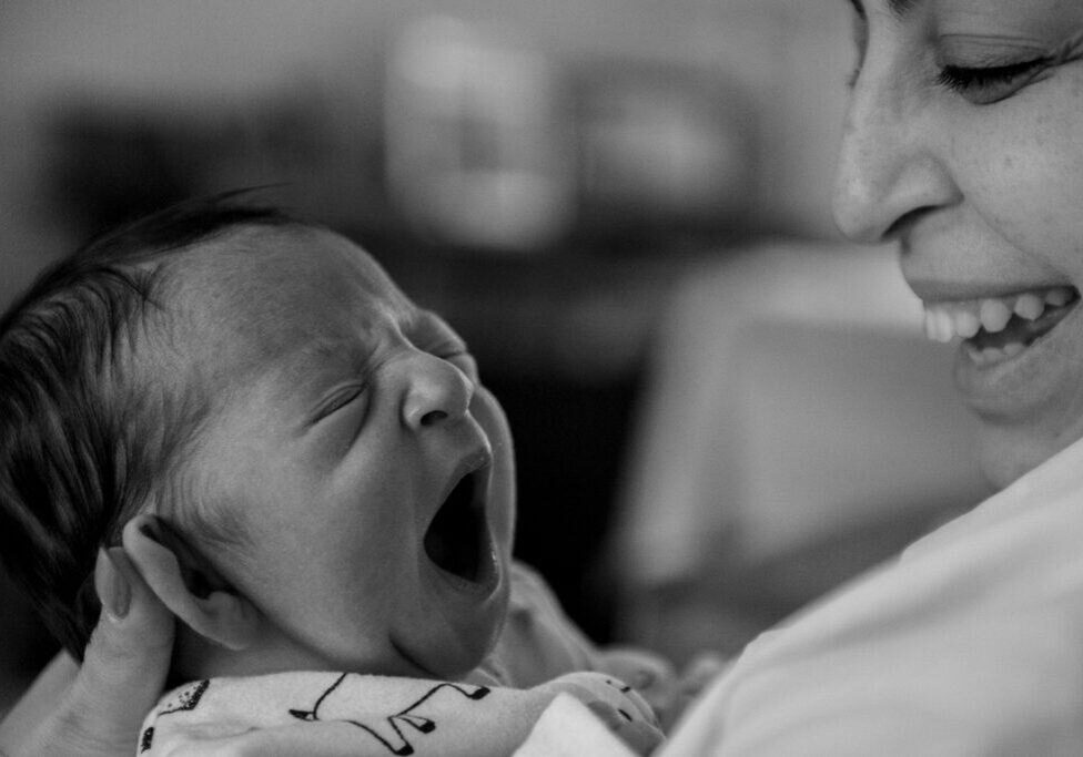 Toronto birth photo of newborn yawning